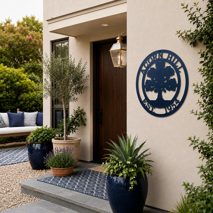 Navy blue oak tree family name metal sign displayed beside modern front door