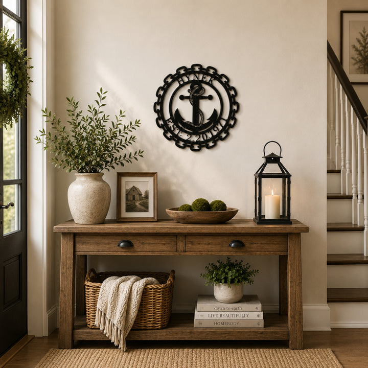 Personalized anchor monogram metal wall sign displayed above a wooden bench with modern farmhouse porch décor and potted plants