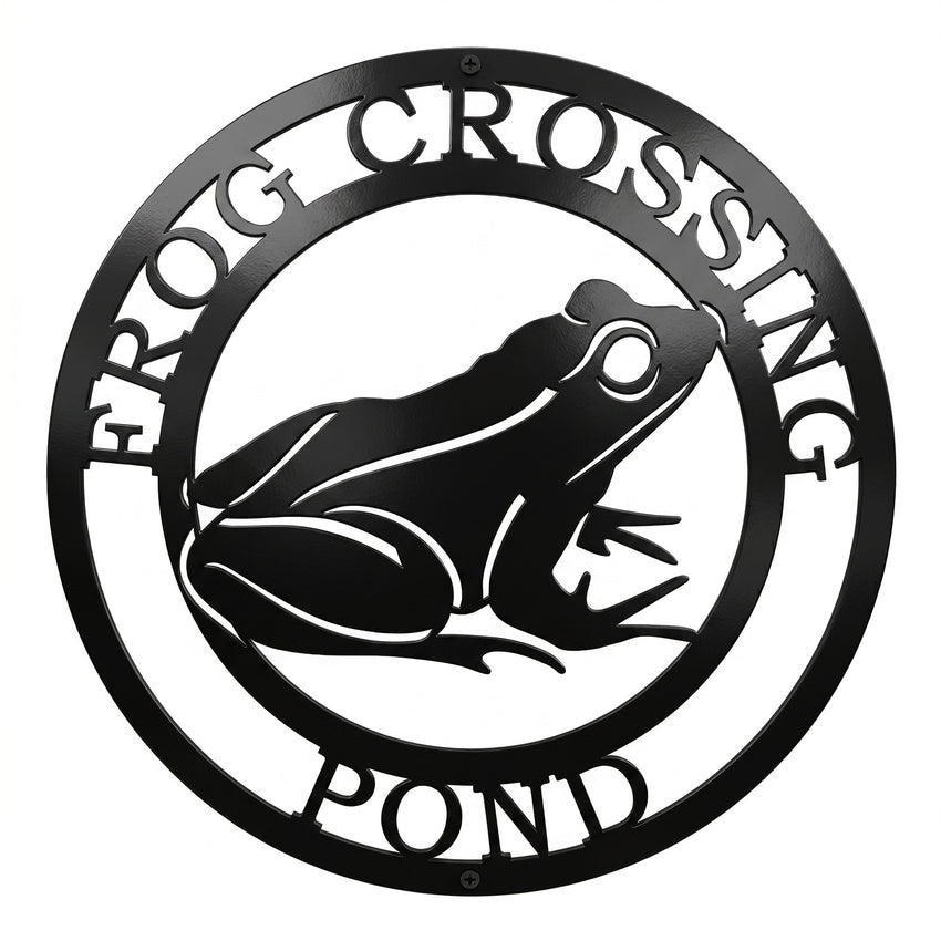 Black frog crossing pond metal wall art sign with circular nature design on white background