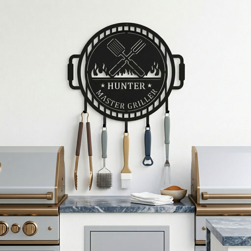 Satin black BBQ grill tool holder metal sign mounted above outdoor counter with grilling tools and barbecue accessories