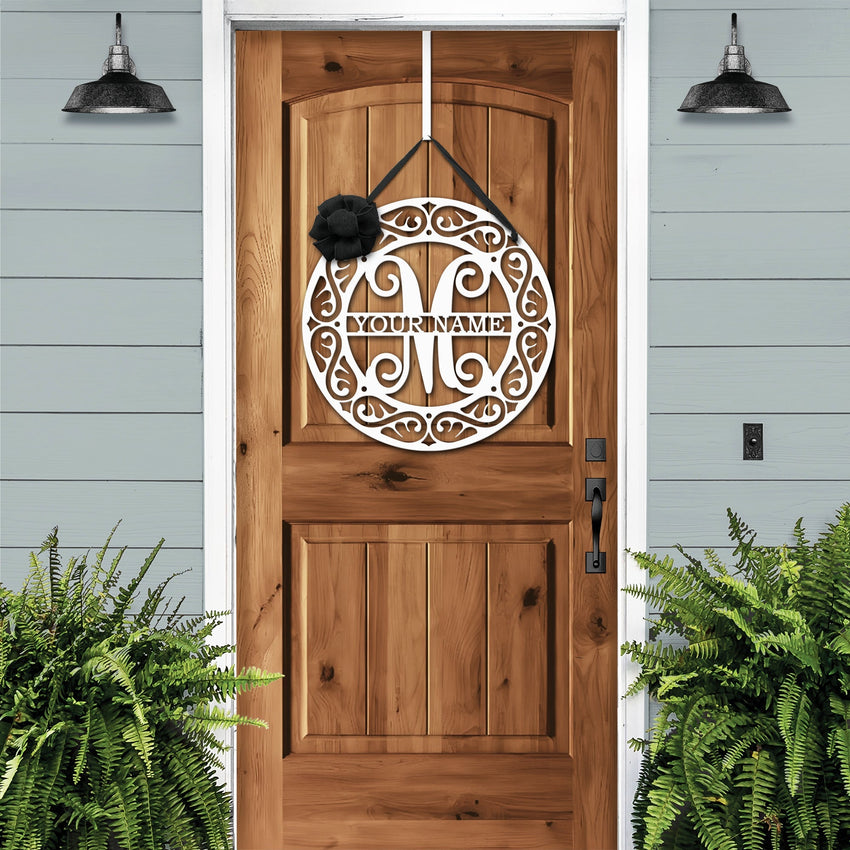 White personalized metal monogram crest door wreath on a wood door