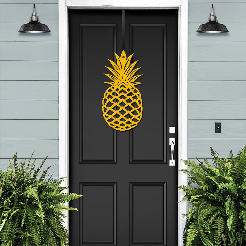 Yellow personalized pineapple metal door wreath on a black front door