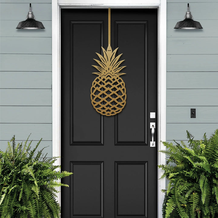 Gold personalized pineapple metal door wreath on a black front door