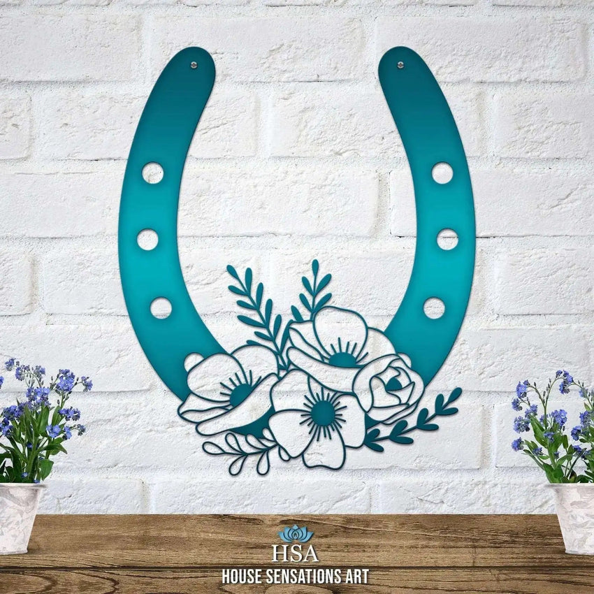 Decorative metal horseshoe wall art with floral design on white brick wall, lucky home décor, blue green finish, House Sensations Art brand sign