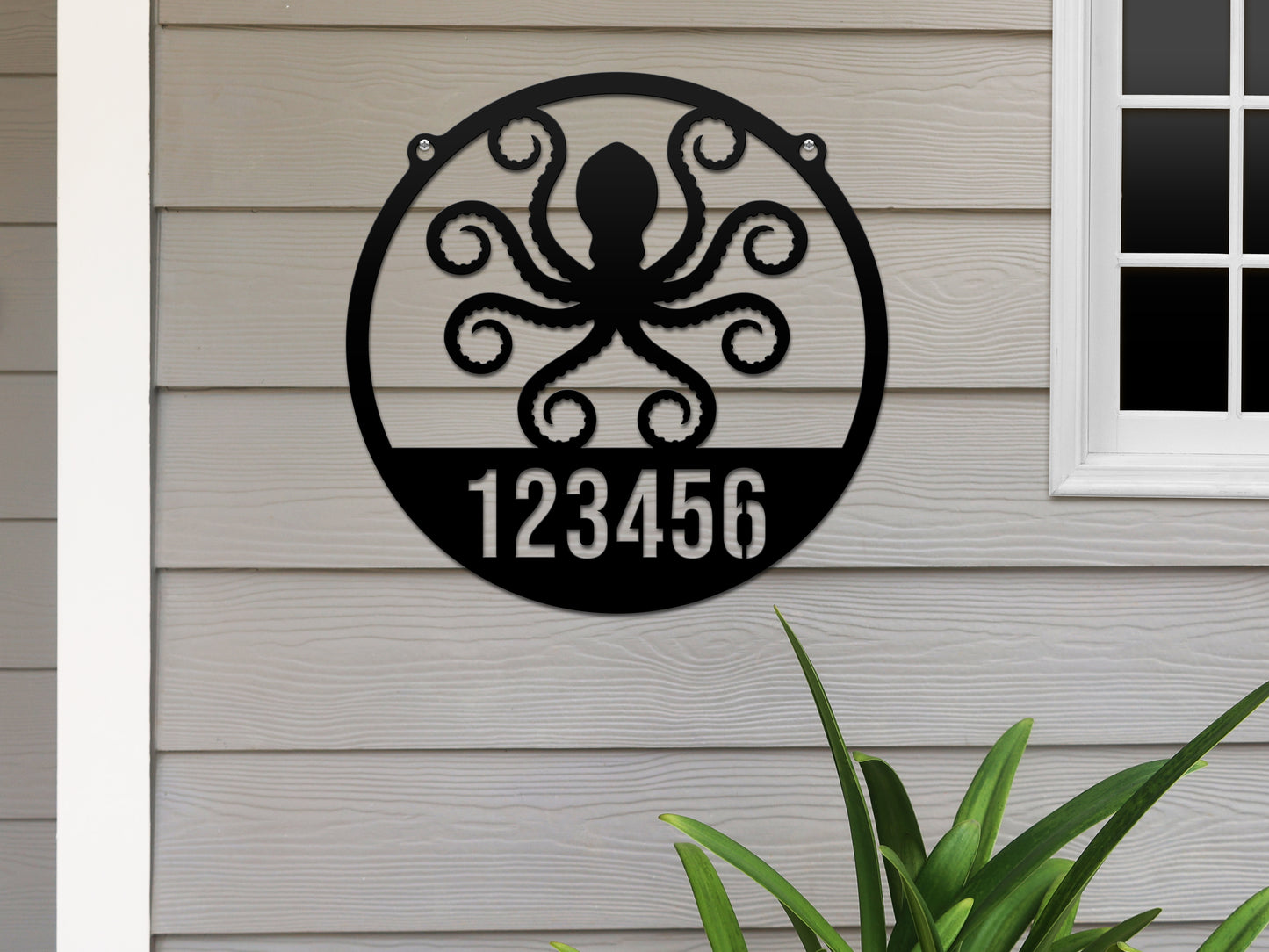 The Octopus House Numbers Address Sign features a black metal octopus design with cut-out street numbers, ideal for beach-themed home decor. Perfect for outdoor use, showcasing custom street numbers.