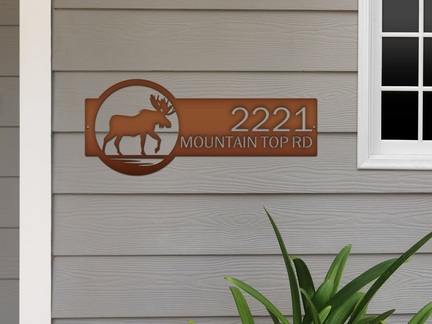 Moose Cabin Address Sign displaying a metal moose with antlers and custom house numbers, crafted from laser-cut steel, ideal for enhancing outdoor home décor with weather-resistant features.