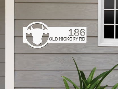 Cattle Farm Monogram Address Sign displayed on a wall alongside a cow head design, showcasing custom street numbers. Perfect for enhancing home décor and gifting, aligning with HouseSensationsArt's custom signage offerings.