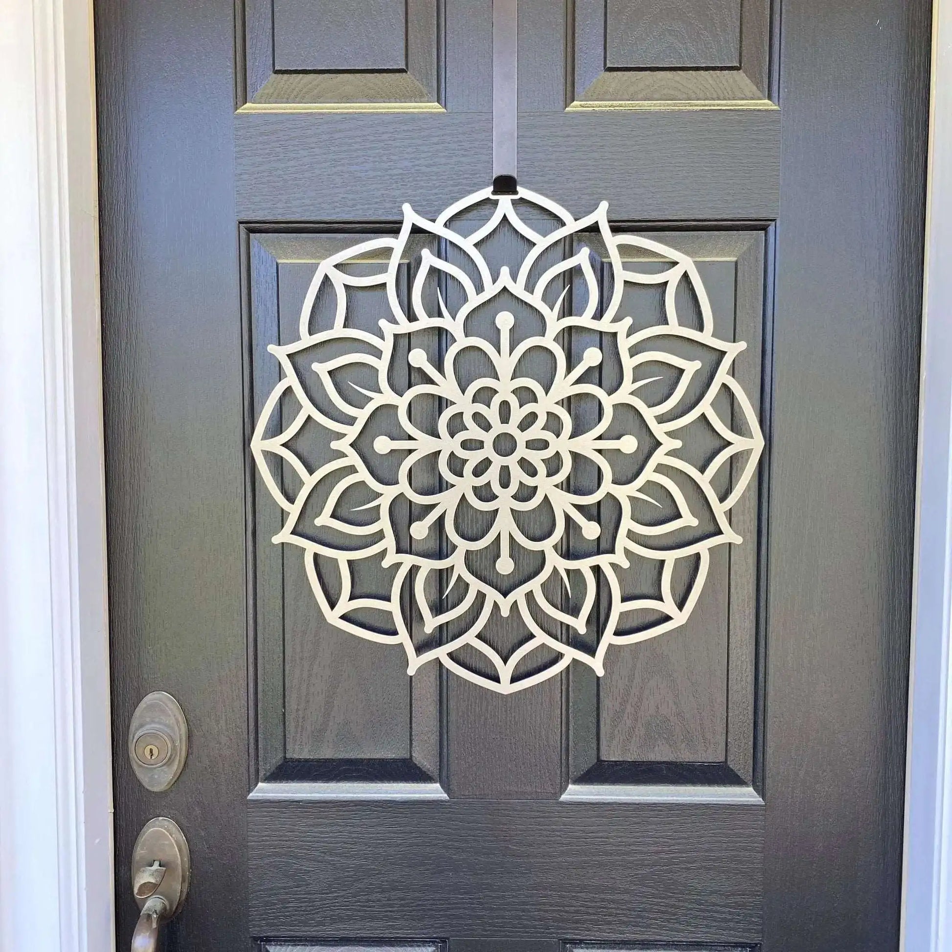 Lotus Mandala Front Door Wreath displayed on a door, showcasing its intricate metal design. This customizable, rust-resistant decor serves as a personalized welcome sign, suitable for home, porch, and garden.