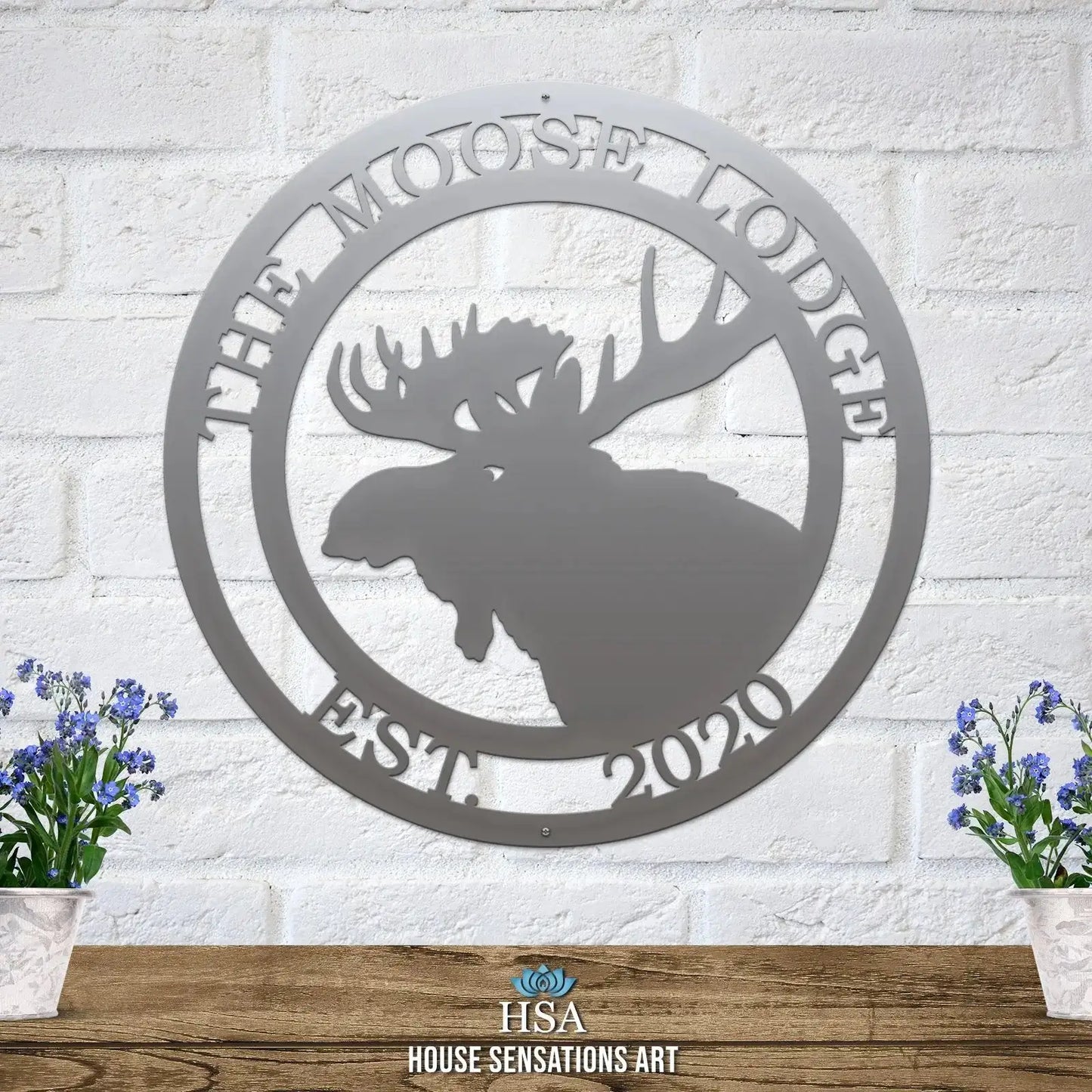 Personalized Moose Hunter Cabin Sign, a custom metal house number plaque on a brick wall, featuring a moose head design. Ideal for outdoor decor in gardens, yards, or farms; perfect housewarming gift.