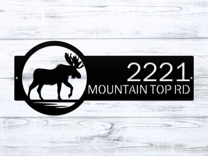 Moose Cabin Address Sign featuring a black moose silhouette with customizable house numbers and text, perfect for enhancing home décor and curb appeal. Durable and weather-resistant, ideal for outdoor use.