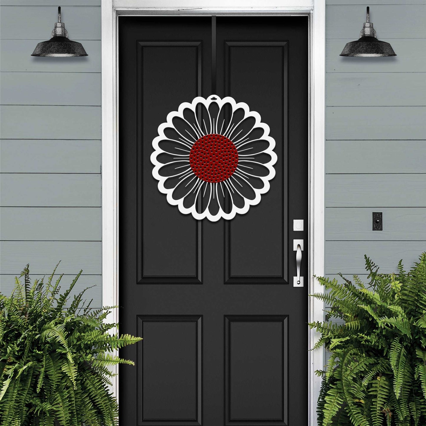 a black front door with a red flower on it