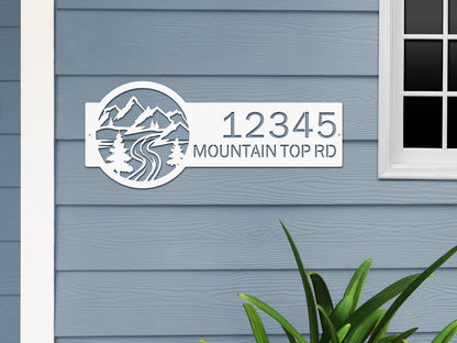 Desert Mountain Monogram Address Plaque displayed on a house wall, featuring laser-cut metal numbers and mountain/tree design, showcasing personalized home decor from HouseSensationsArt.