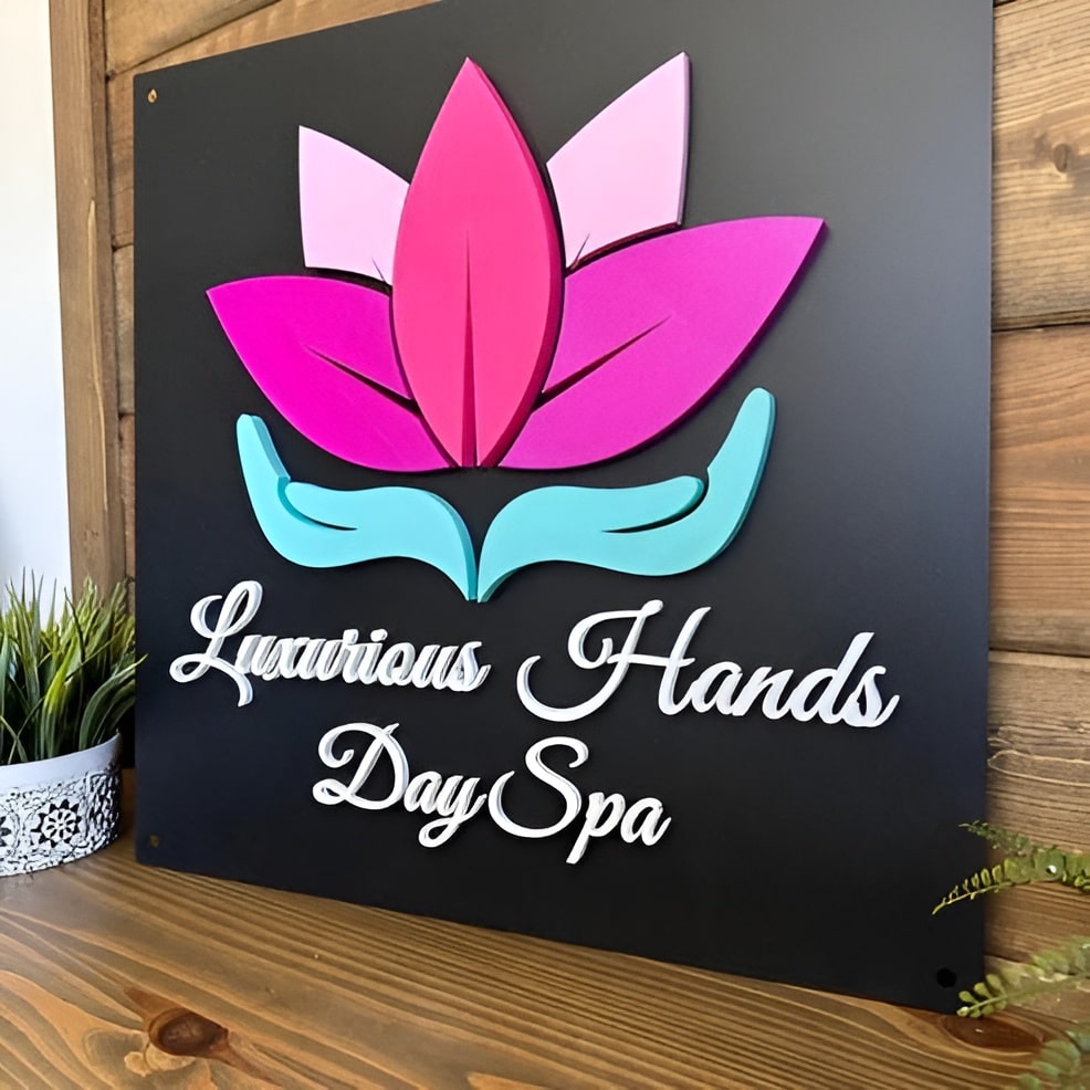 Custom 3D steel business logo sign with pink and blue hands holding a pink flower, “Luxurious Hands Day Spa” text, modern black background spa signage.