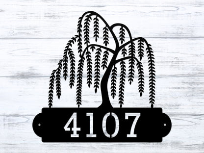 Weeping Willow House Numbers Address Sign featuring a black metal plaque with a tree and customizable cut-out street numbers, perfect for enhancing home décor and serving as a thoughtful housewarming gift.