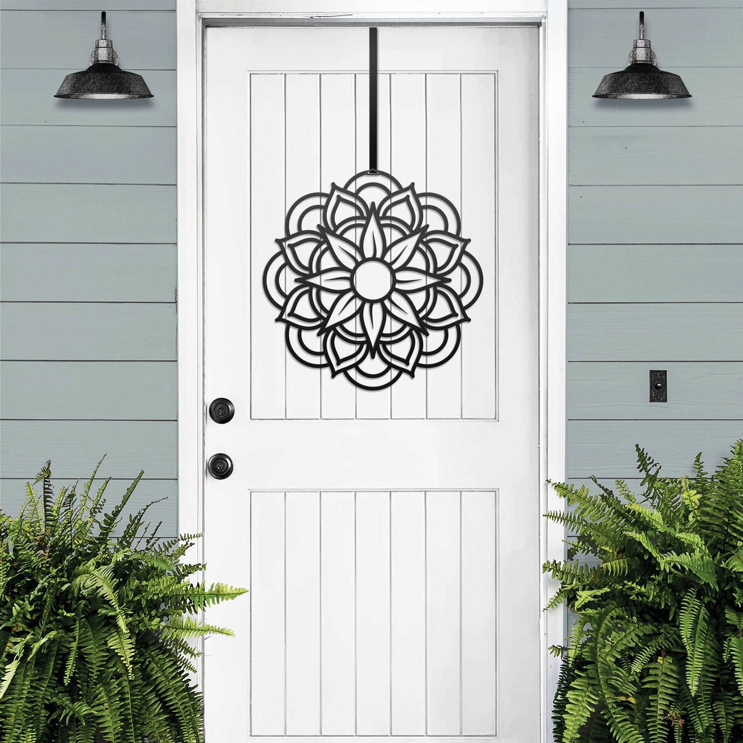 a white front door with a metal flower decoration on it