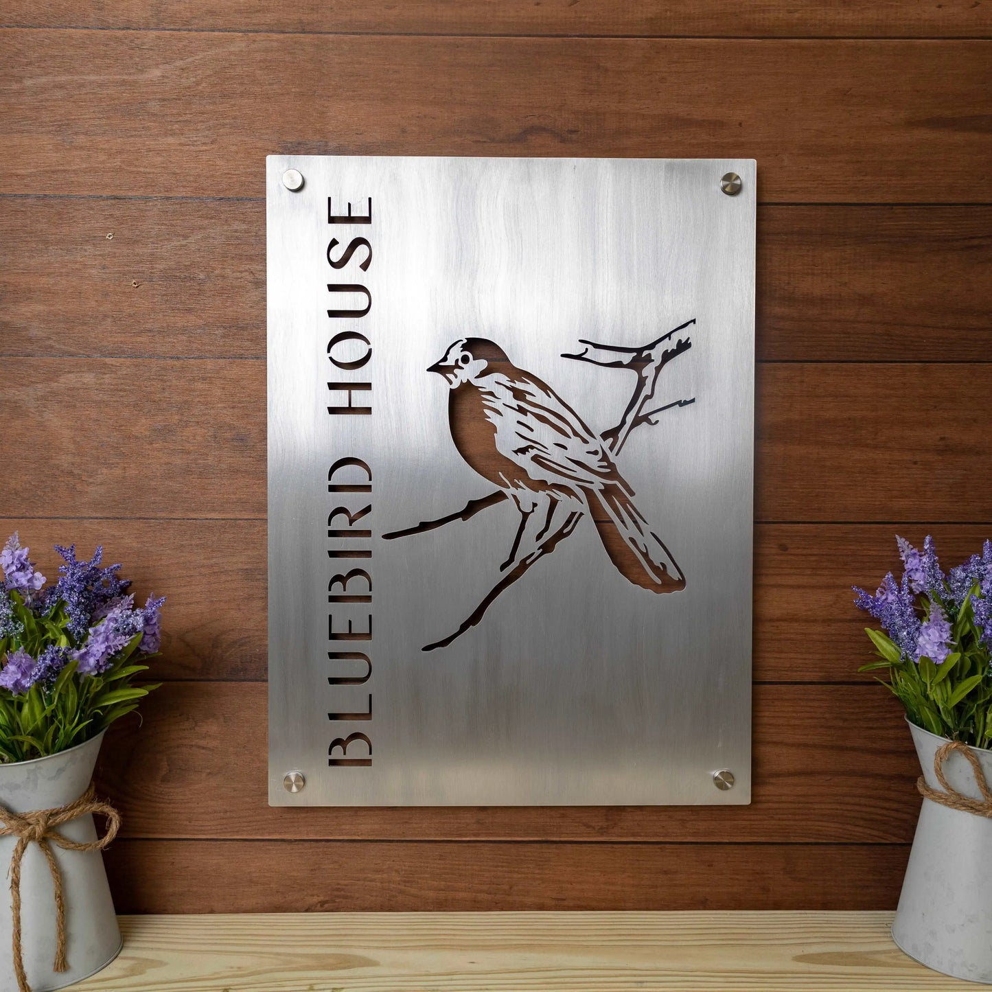 Hand Brushed Aluminum Business Logo Sign featuring a metal bird design, complemented by two vases of flowers—ideal for storefronts, office walls, and company logo displays.