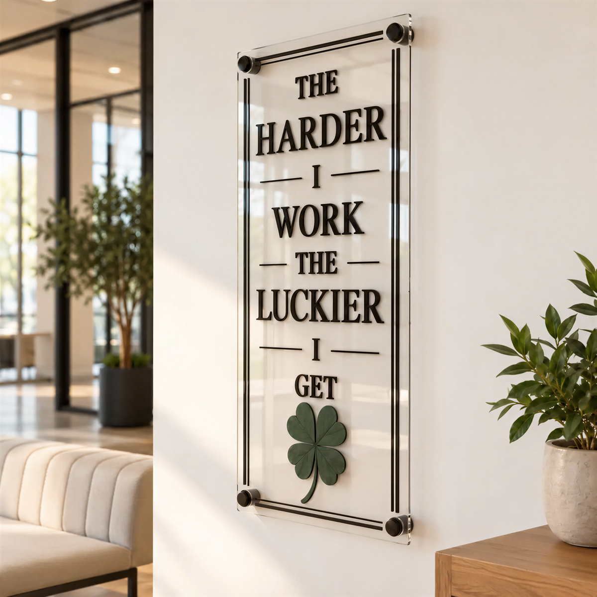 a motivational quote on a wall, which reads "THE HARDER I WORK THE LUCKIER I GET".