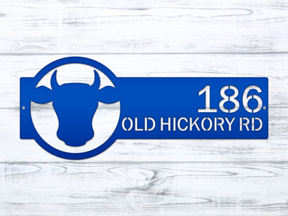 Cattle Farm Monogram Address Sign displayed with a blue cow head design, showcasing street numbers. Ideal for enhancing home décor with a personalized, weather-resistant touch. Perfect for housewarming gifts.