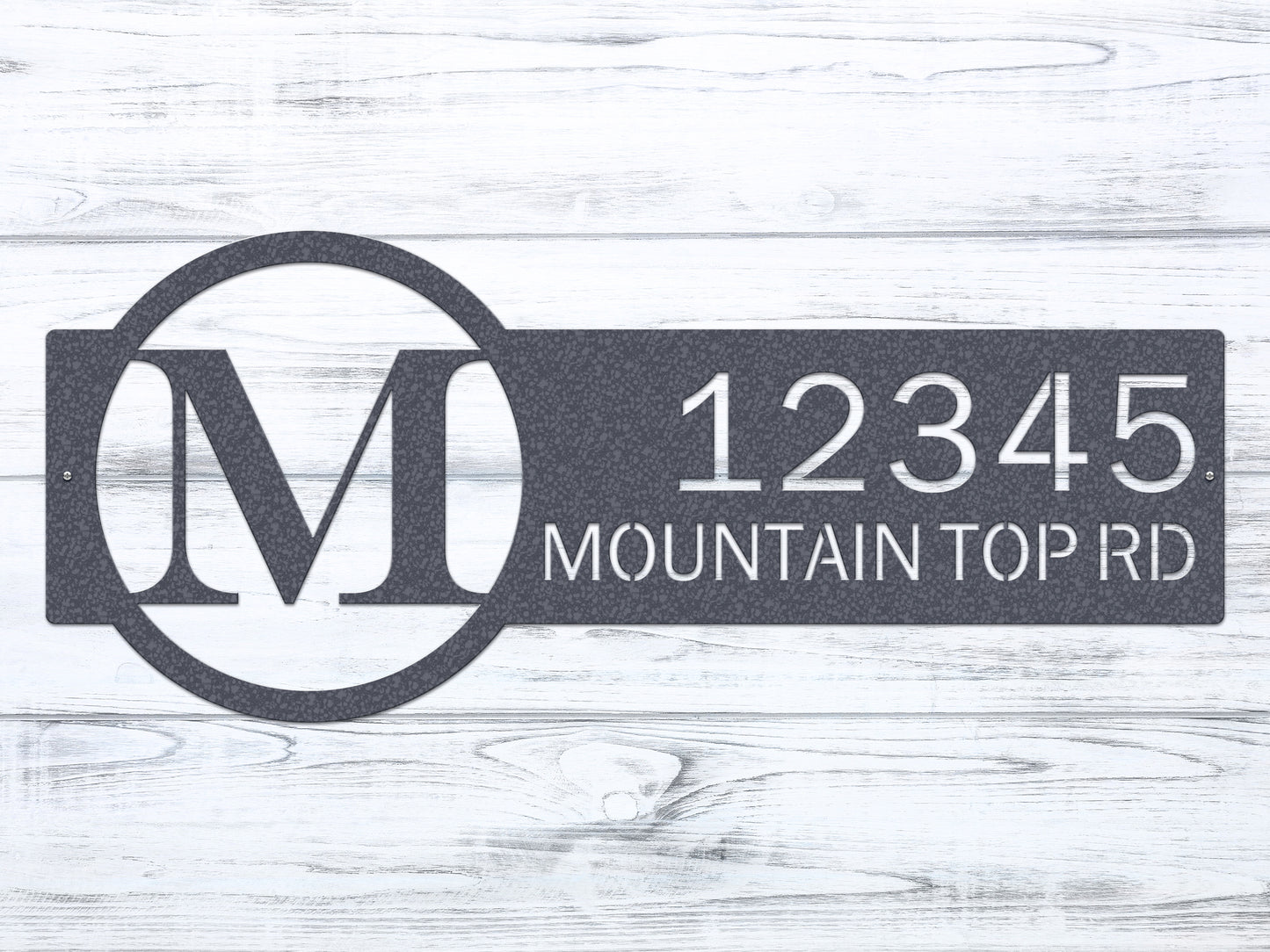 Metal Monogram Address Sign with custom house numbers and street name, showcasing a classic monogram within a circle on a white wood surface, highlighting weather-resistant craftsmanship for home décor.