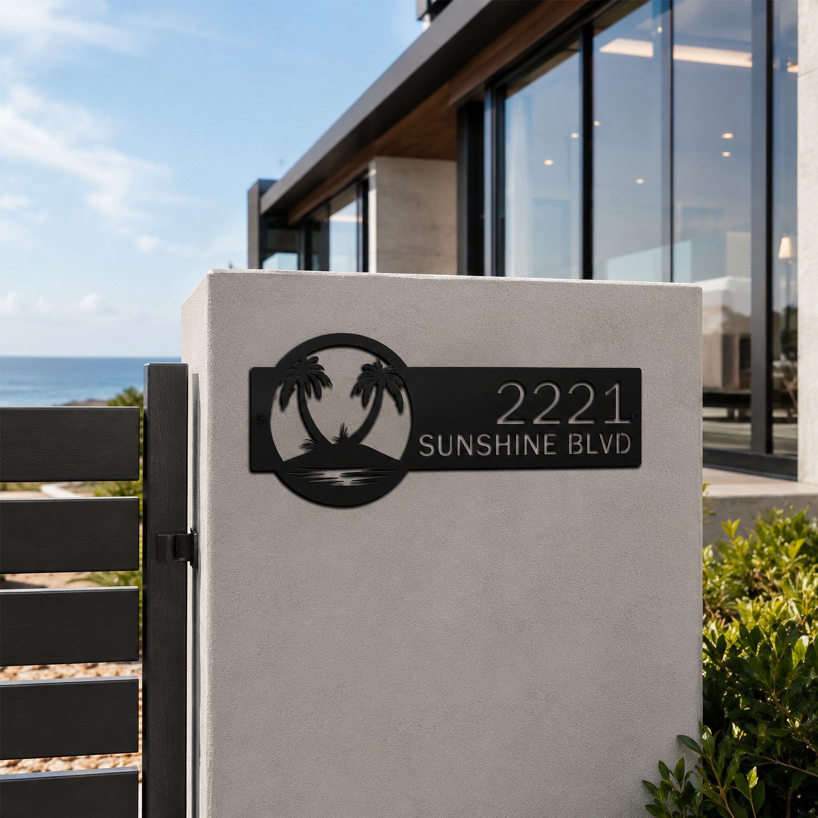 Black tropical palm tree metal house number sign displayed on coastal home gate pillar with ocean background