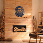 Custom bear lodge metal wall sign displayed above modern fireplace in cozy rustic cabin interior with natural wood accents