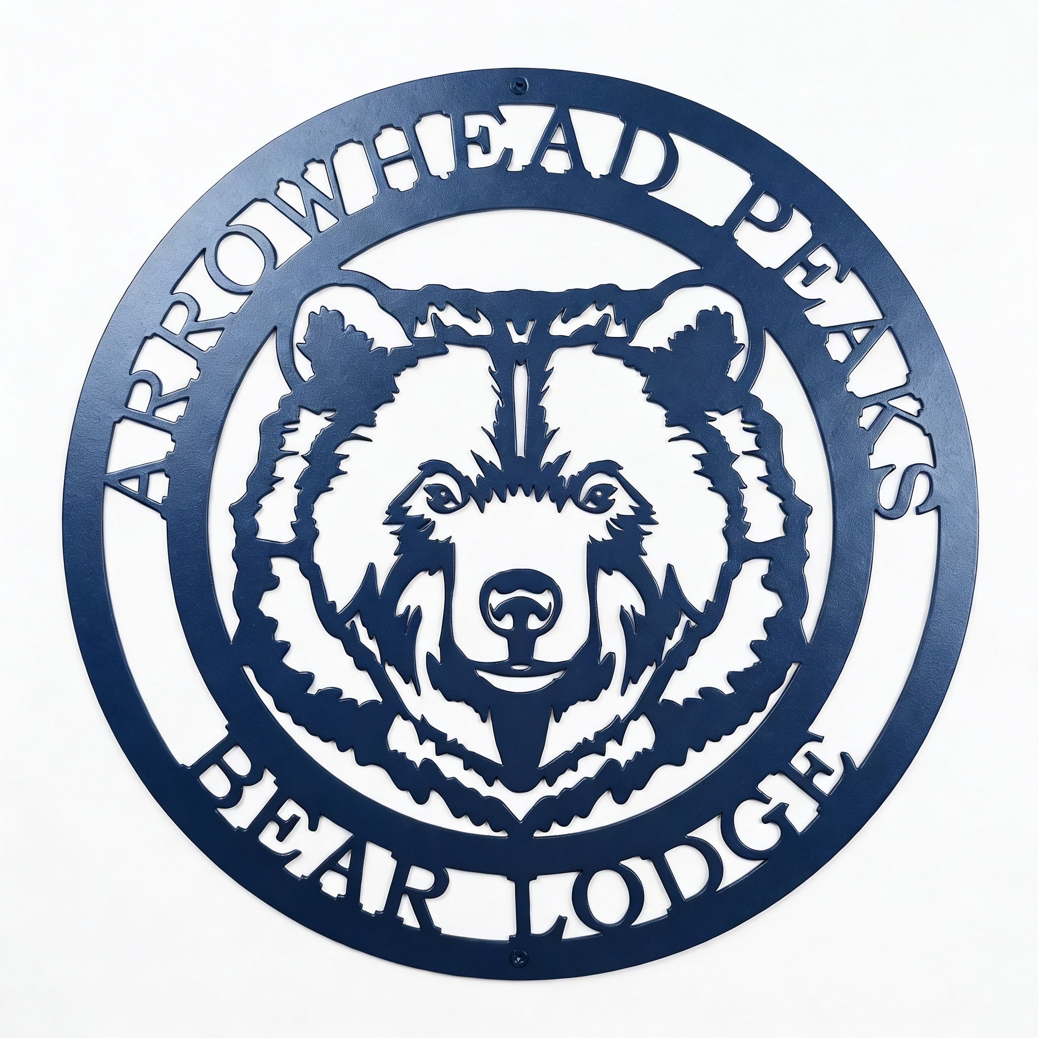 Custom Arrowhead Peaks Bear Lodge metal sign mounted above wooden shelf with books and decorative plants on white shiplap wall