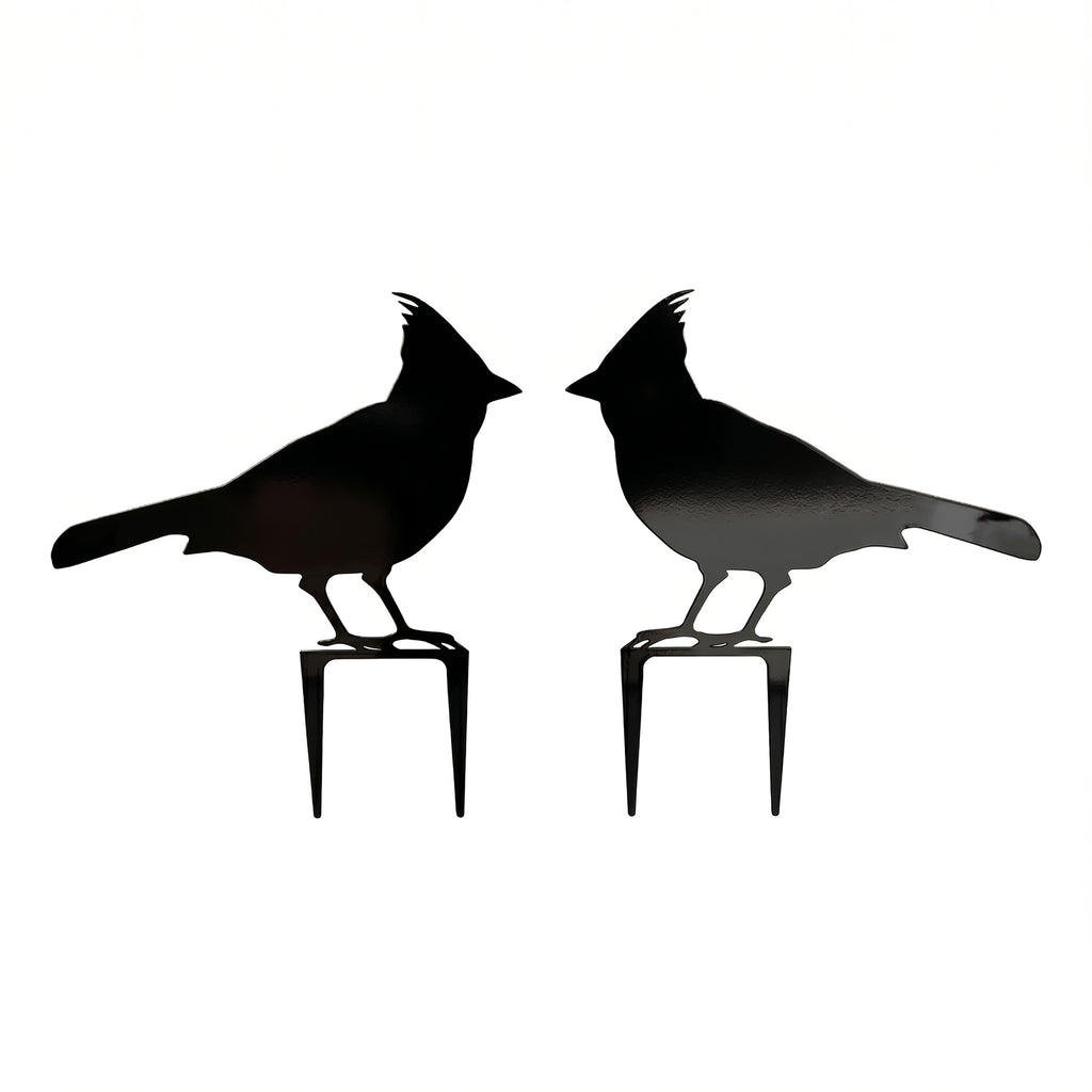 Pair of black cardinal metal garden stakes with mirrored bird silhouettes on a clean white background