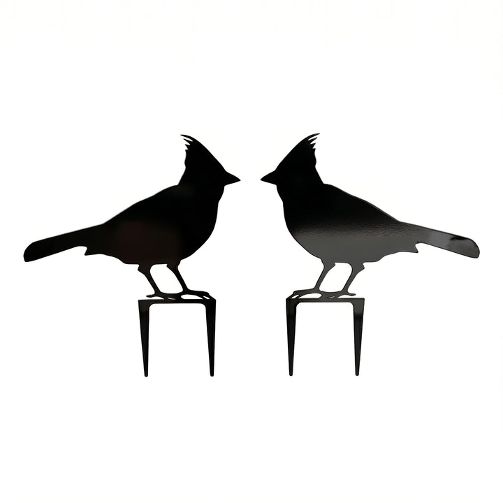 Pair of black cardinal metal garden stakes with mirrored bird silhouettes on a clean white background