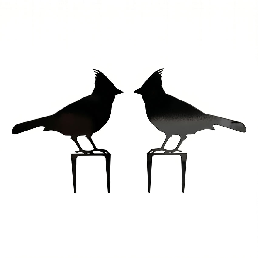 Pair of black cardinal metal garden stakes with mirrored bird silhouettes on a clean white background