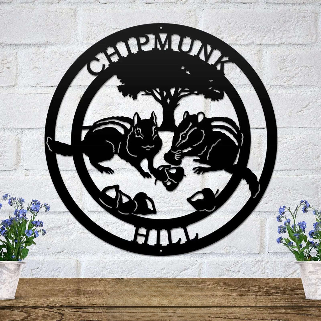 Black chipmunk hollow metal wall decor with woodland animal scene and tree silhouette mounted on white brick wall farmhouse style art