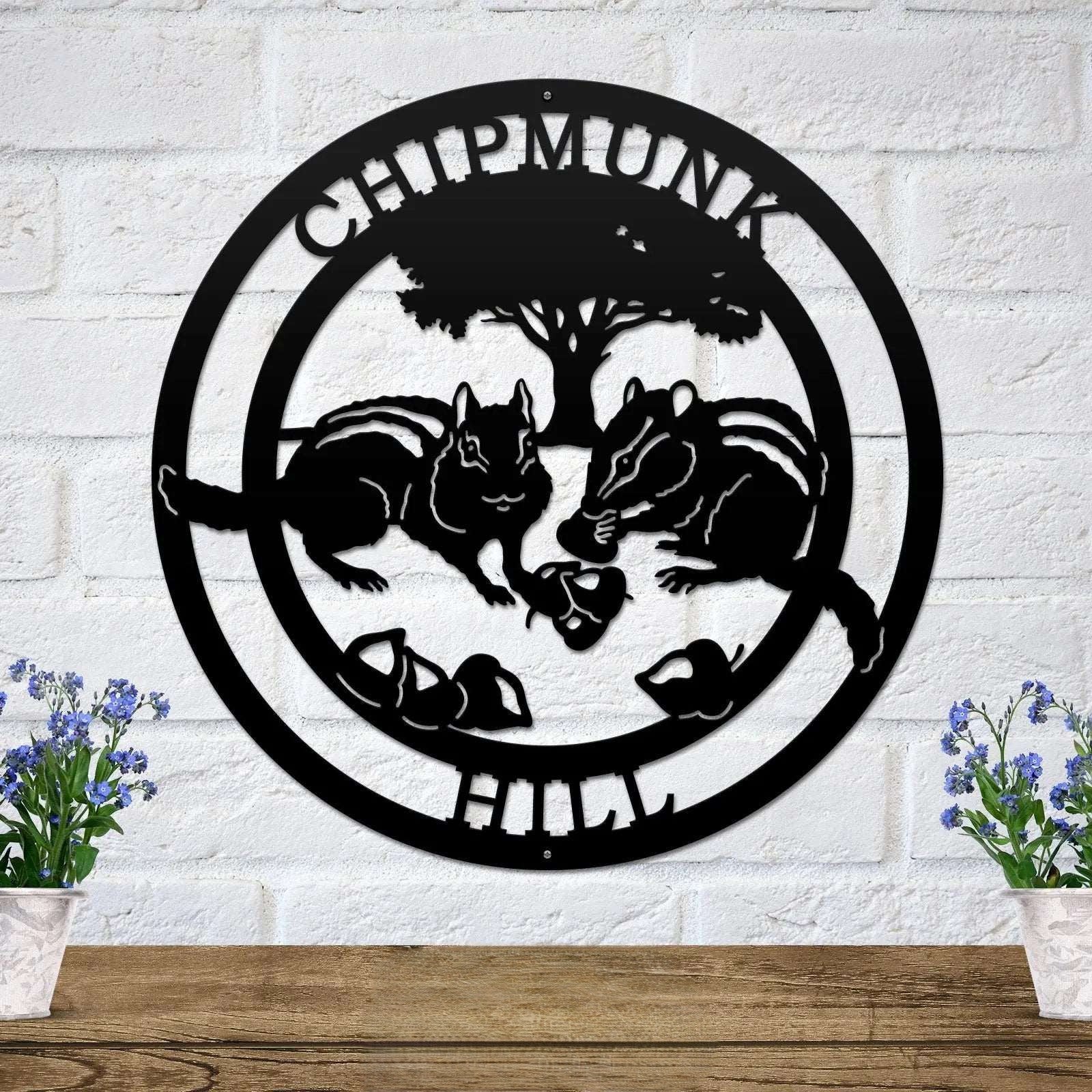 Black chipmunk hollow metal wall decor with woodland animal scene and tree silhouette mounted on white brick wall farmhouse style art