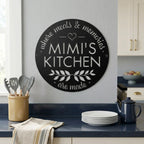 Black mimis kitchen metal wall decor mounted in modern kitchen beside plates utensils and countertop accessories