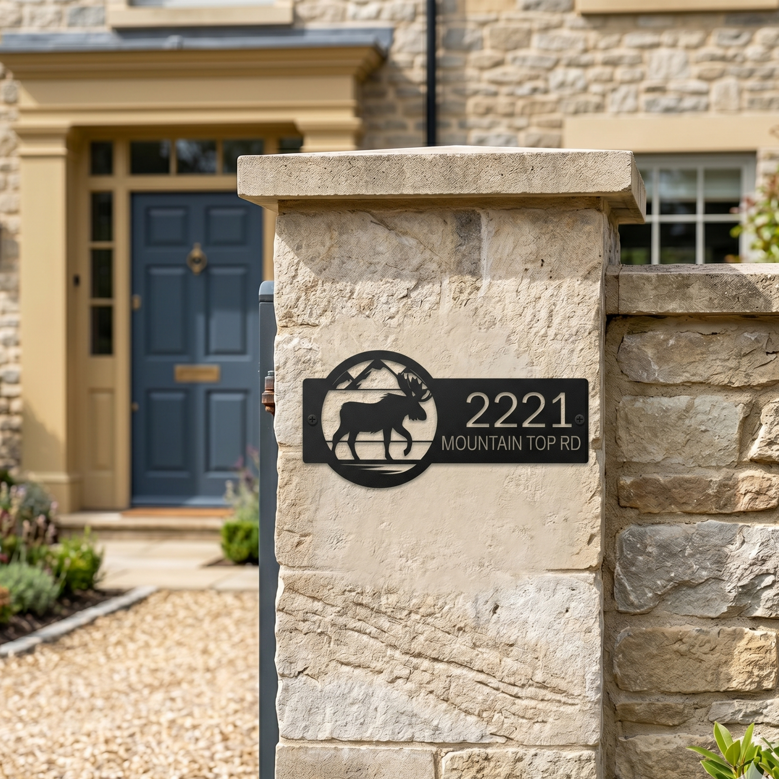 Rustic black moose address plaque with house number on stone pillar near front entrance