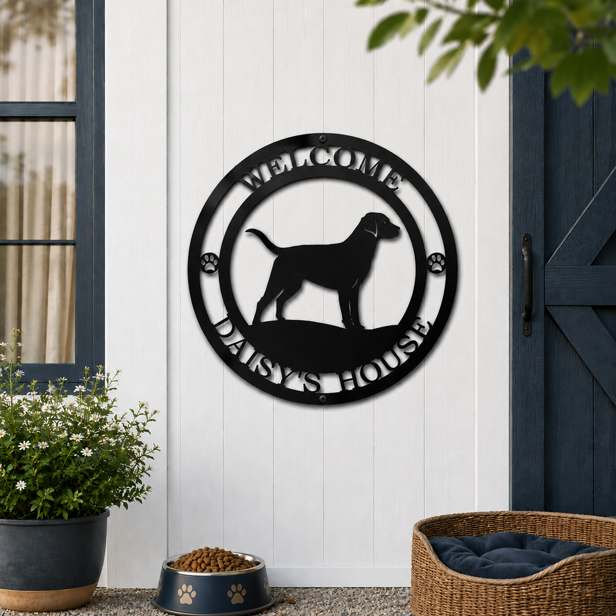 Black personalized dog welcome metal sign mounted on white shed wall beside pet bed and dog bowl displaying Daisy's House text