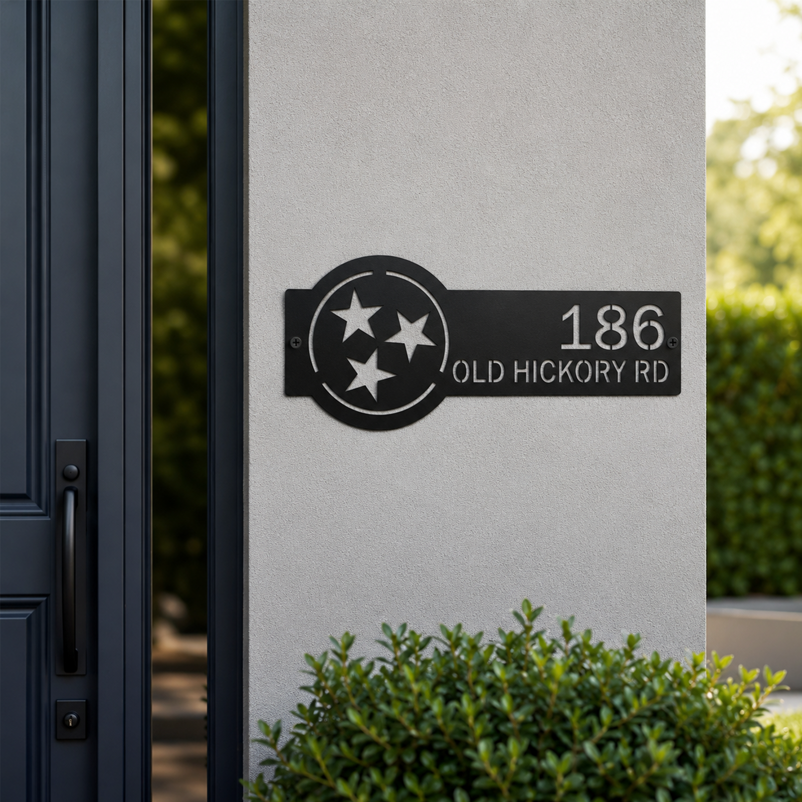 Black Tennessee tri star metal address sign with custom house number and street name mounted beside front door