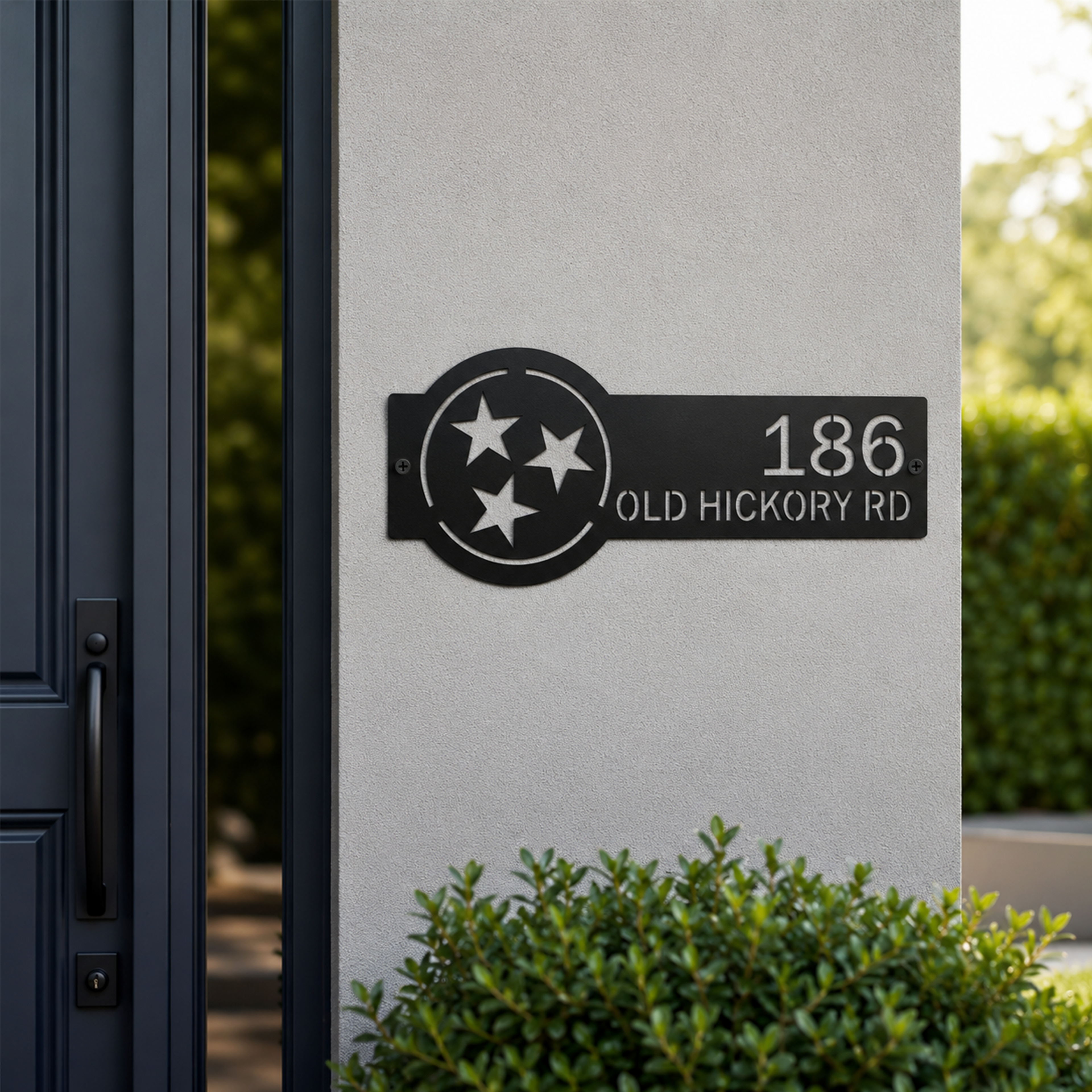 Black Tennessee tri star metal address sign with custom house number and street name mounted beside front door
