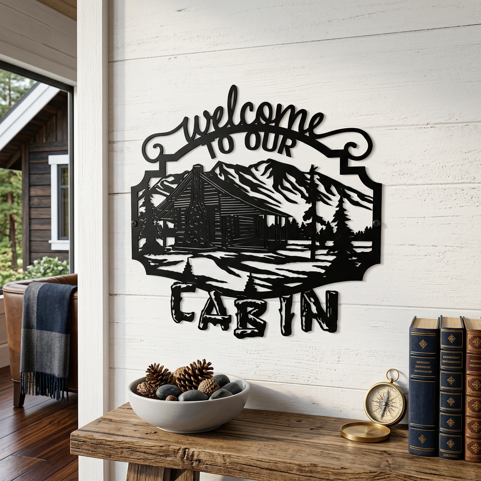Black welcome to our cabin metal wall art with mountain lodge scene displayed above rustic table decor