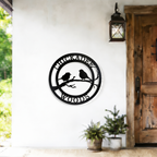 Black chickadee woods metal wall decor displayed beside rustic wooden door