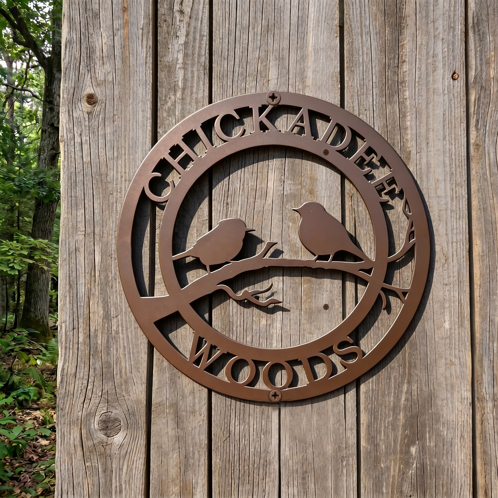 Brown chickadee woods metal sign mounted on weathered wooden outdoor wall