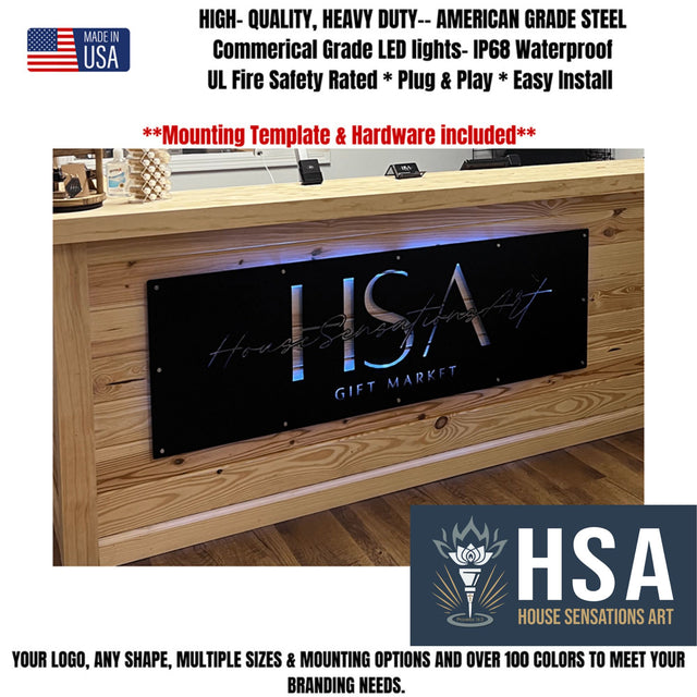 Custom matte black LED backlit metal sign with HSA branding, illuminated feature text on powder coated steel signage displayed on wooden surface, modern business logo sign showcasing product features for indoor display or front door branding