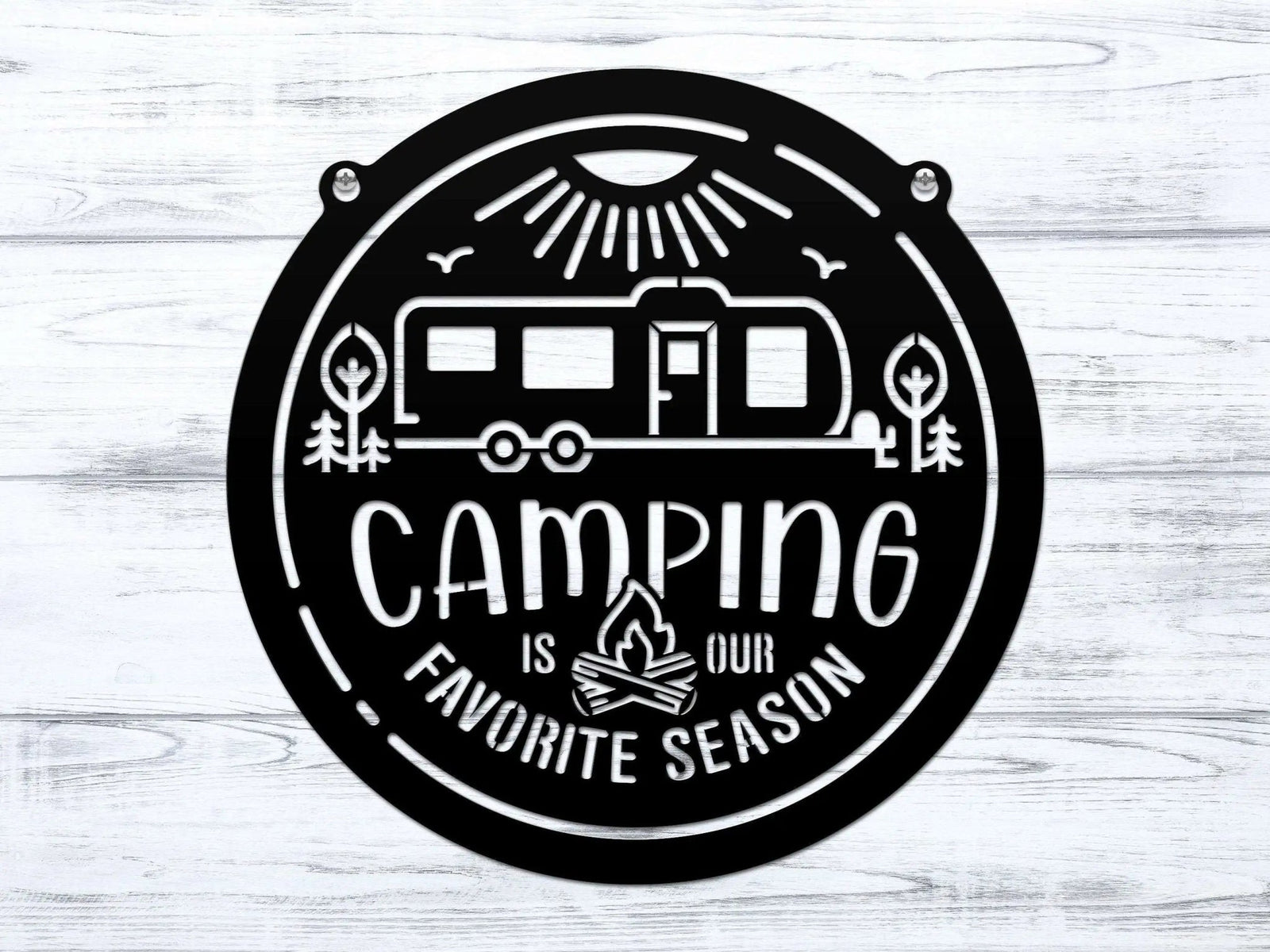 Circular metal sign featuring a camping-themed design with text, displayed on a white wooden background, highlighting rustic style and durable decorative craftsmanship.