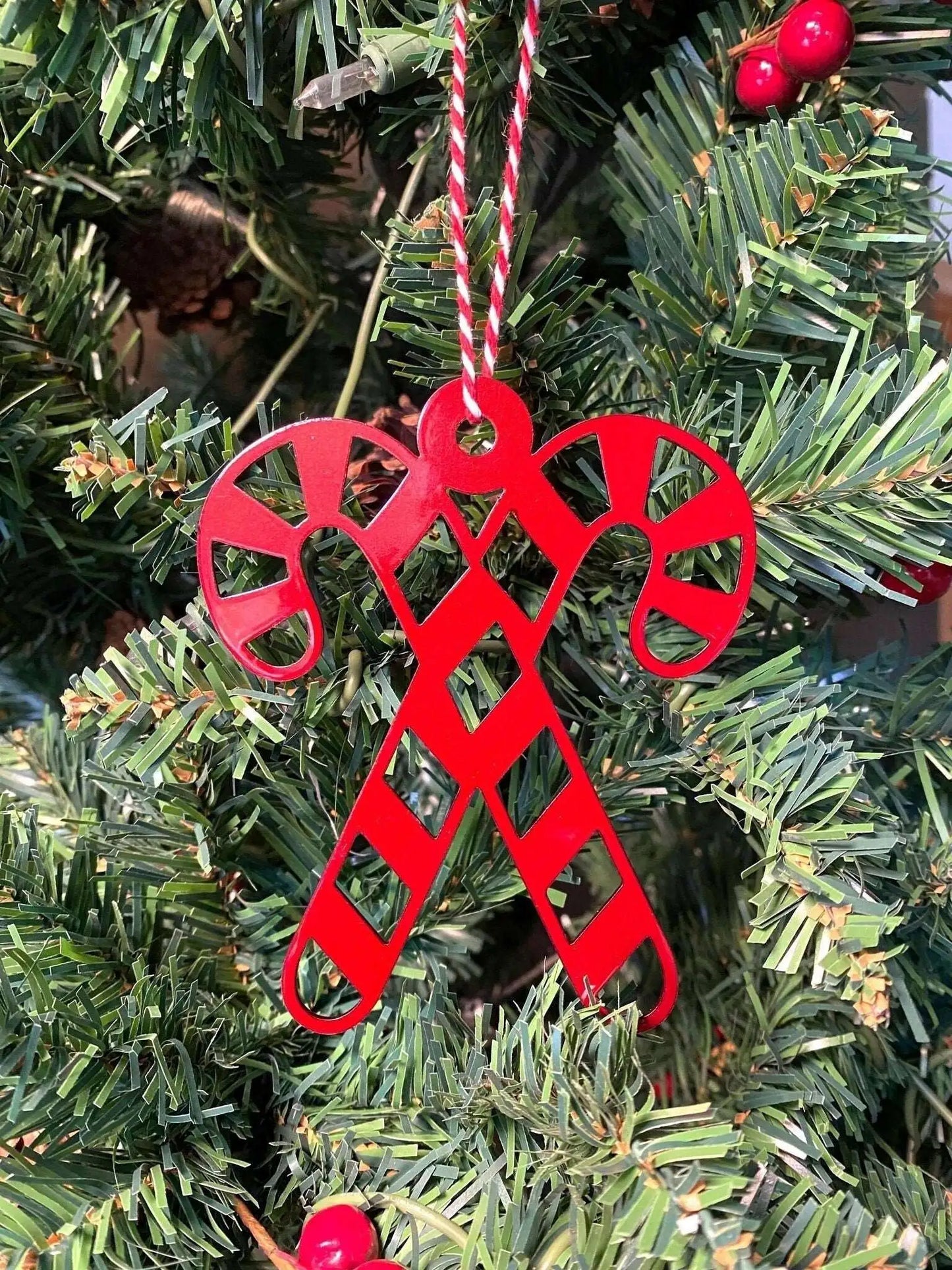 Candy Canes Christmas Ornament - Metal Tree Ornaments feature a red candy cane design hanging on a Christmas tree, showcasing durable craftsmanship and festive charm, ideal for enhancing holiday décor.