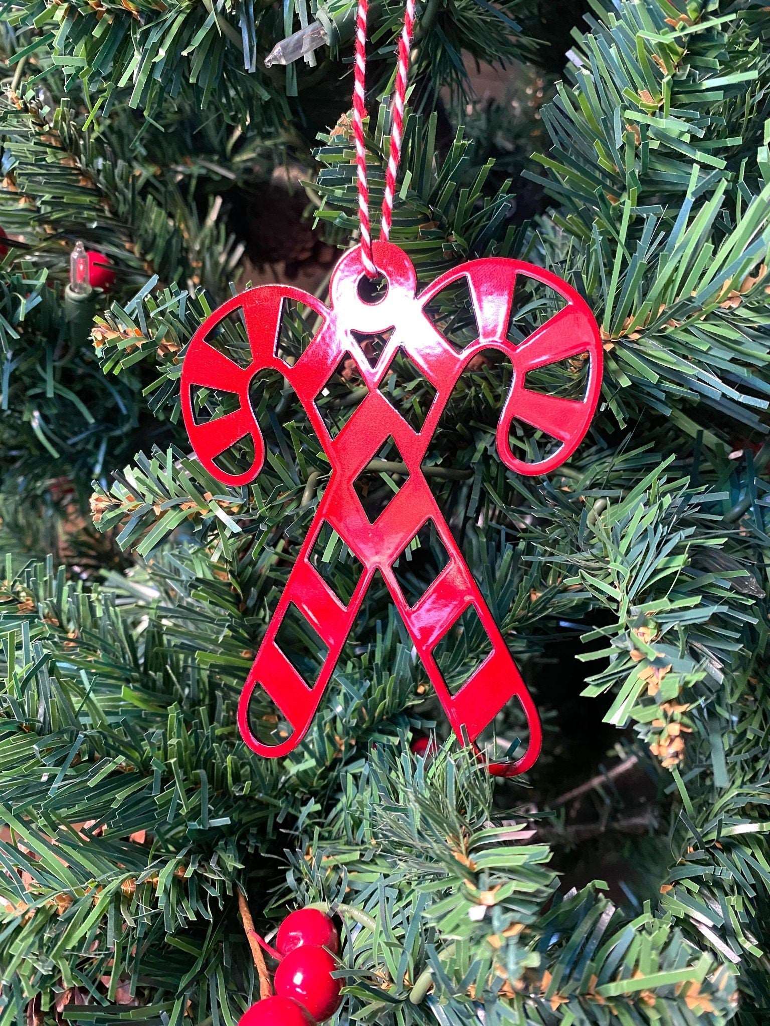 Candy Cane Christmas Ornament - Metal Tree Ornaments: A red candy cane ornament hangs on a Christmas tree, showcasing durable construction and festive design, perfect for holiday décor and gifting.