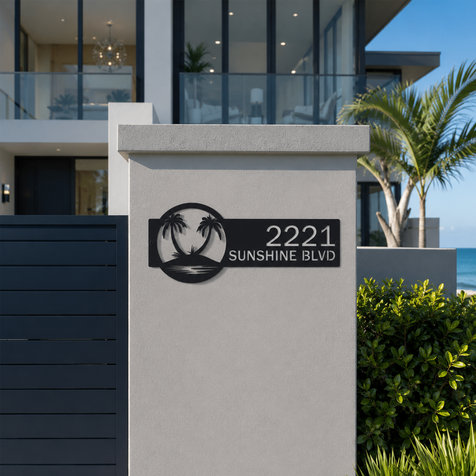 Black palm tree address sign with custom house numbers mounted on modern beachfront property entry wall