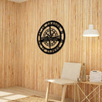 Personalized Lake Sinclair compass metal wall décor displayed on natural wood panel wall in cozy modern interior setting
