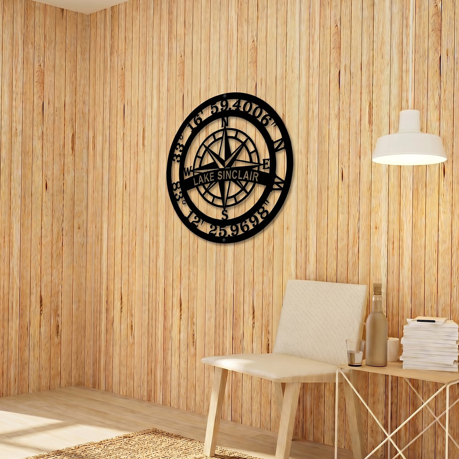 Personalized Lake Sinclair compass metal wall décor displayed on natural wood panel wall in cozy modern interior setting