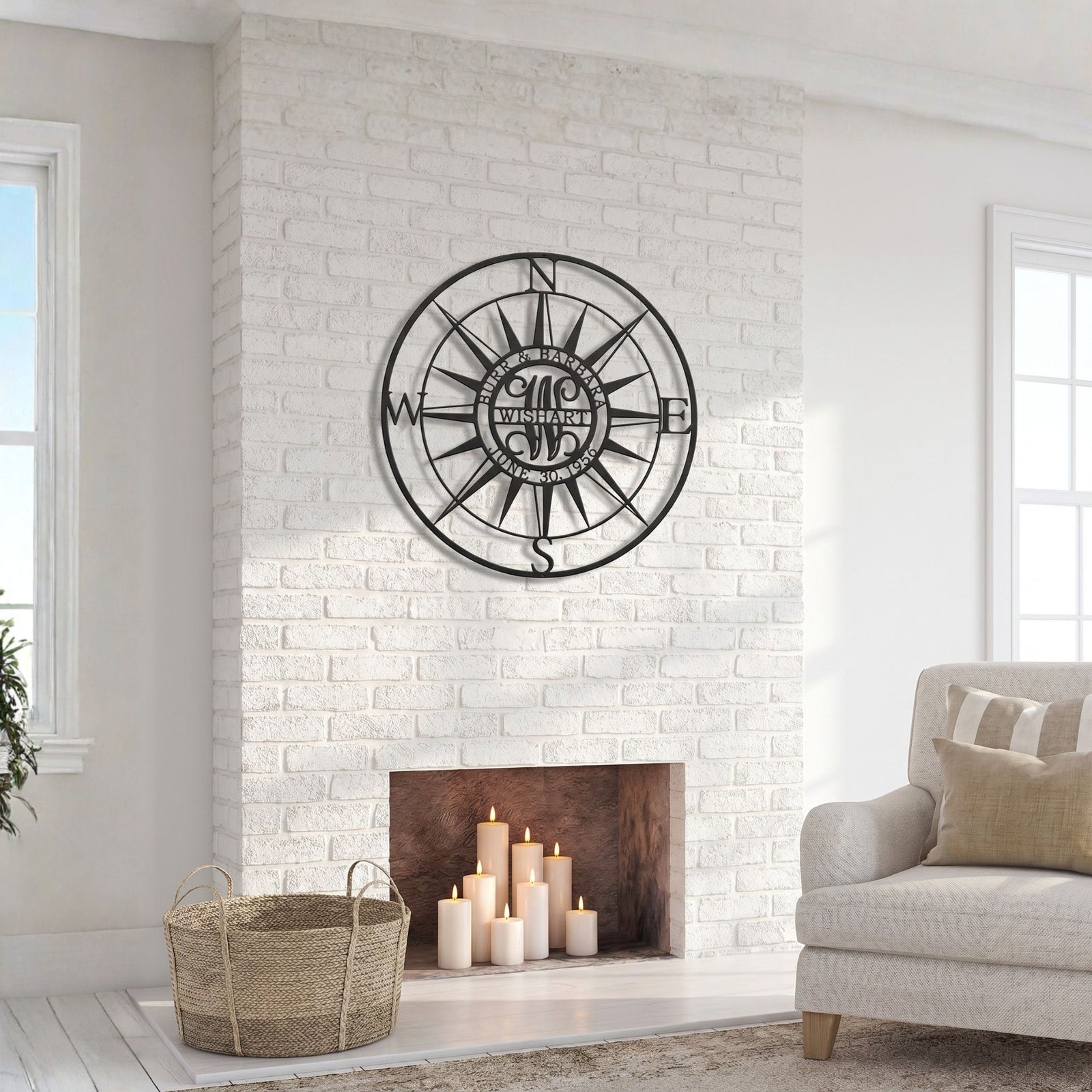 Custom compass rose metal wall sign mounted above white brick fireplace in cozy farmhouse living room