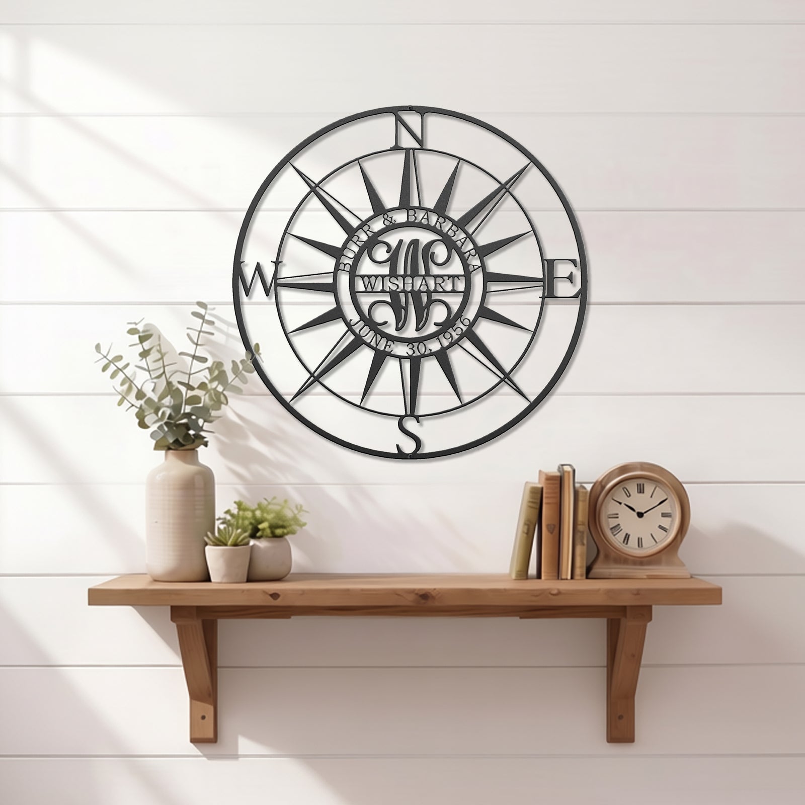 Custom compass rose metal wall art displayed above wooden shelf with minimalist farmhouse decor and clock