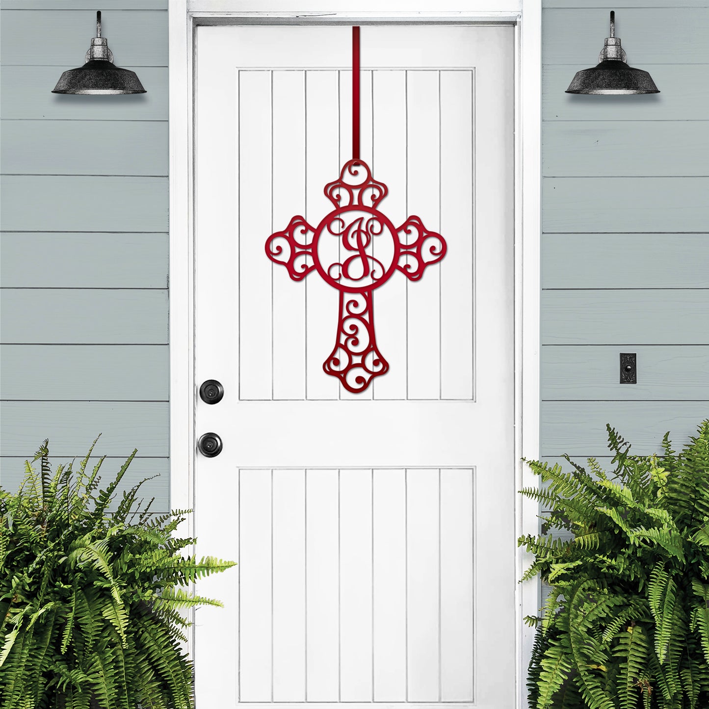 Custom Swirl Monogram Cross Door Sign displayed on a white door, featuring a red cross and monogram letter. Ideal for home and garden decor, crafted from durable, weather-resistant metal for indoor or outdoor use.