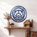 Custom Arrowhead Peaks Bear Lodge metal sign mounted above wooden shelf with books and decorative plants on white shiplap wall